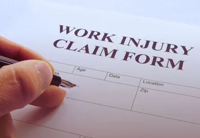 Man filling out work injury claim form. What are the requirements for workers' compensation eligibility.